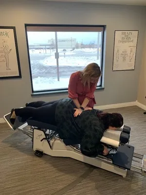 Chiropractor Kenosha WI Amanda Binder Adjusting Patient Color