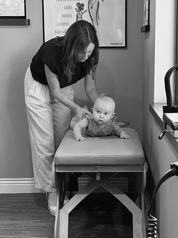 Chiropractor Kenosha WI Kellen Binder Adjusting Baby